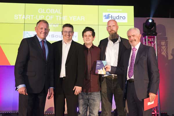 BBC news presenter Jamie Owen, left, and Tony Connelly of Hydro Industries, right, present the award to Matthew John, Mike Barbero, and Ed Brooks of ProfitSourcery.com