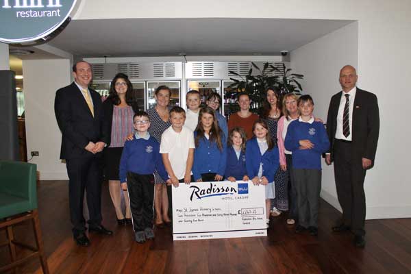 HOTEL: Staff at Radisson Blu present the pupils with their cheque