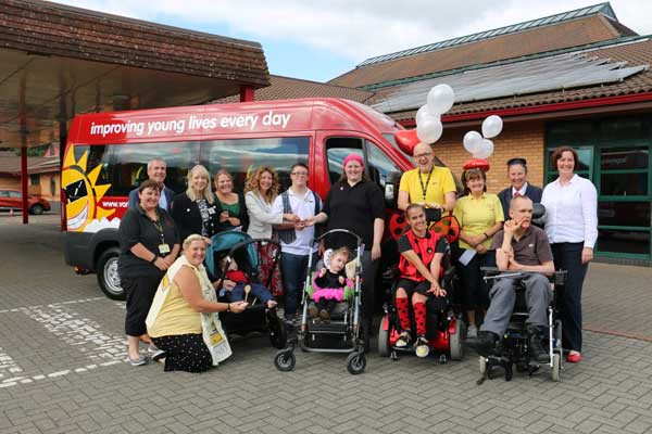 Pupils and staff from Trinity Fields School being presented with their Sunshine Coach