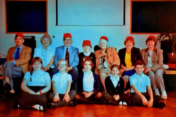 AWARDED: Tommy Cooper Society members and Bedwas Junior School pupils with trophy winner Corey Leggatt (centre, back row)