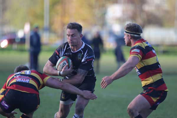 FALLING SHORT: Bedwas full-back Aaron Bramwell takes on two Carmarthen defenders