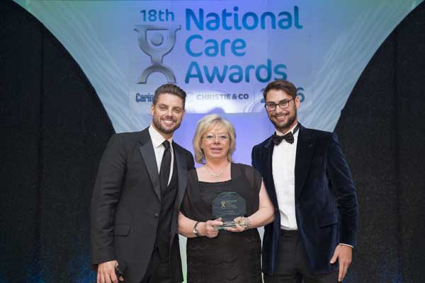AWARD: Caroline Davies, centre, is presented with her award by singer Keith Duffy, left 