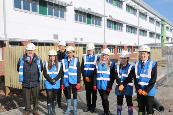 Cllr Derek Havard, Cabinet Member For Education and Lifelong Learning, with headteacher Tim Williams and pupils of Islwyn High