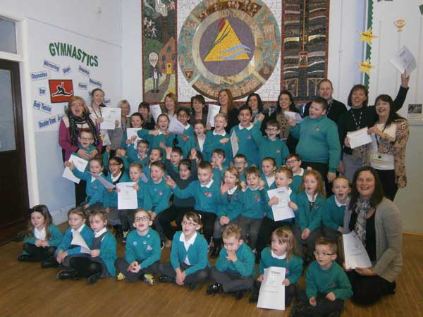 IT'S ALL GOOD: Pupils and staff from Tyn-y-Wern Primary School celebrate their Estyn report