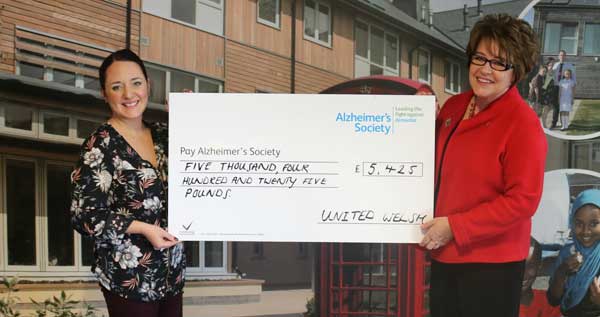 Rhia Jones, of Alzheimer’s Society Cymru, left, receives the donation from United Welsh Chief Executive Lynda Sagona