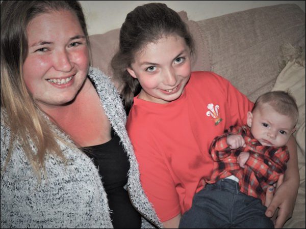 ALL SMILES: Shannon Cox, centre, has been praised for delivering her baby brother Riley while on the phone to emergency services