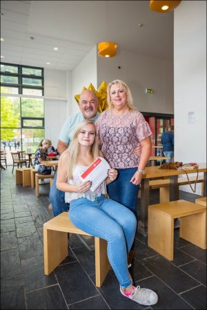 Katie Higgs, from Blackwood, celebrates her A Levels with her parents at Coleg Gwent