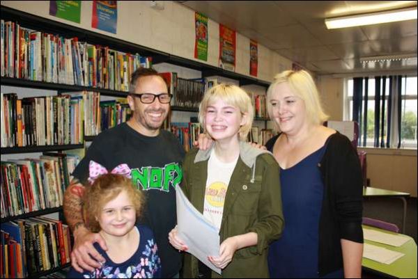 Poppy Hunt, from Blackwood Comprehensive School, celebrates her three A*s, four As, three Bs and a C, with her family
