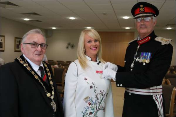 June Thomas receives her British Empire Medal from the Lord Lieutenant of Gwent, Brigadier Robert Aitken CBE and the Mayor Cllr John Bevan