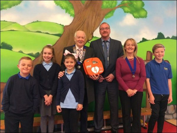 Cllr Bill Allen, left, with headteacher John Farmer, Cllr Susan Dickens and pupils from Hendre Junior School