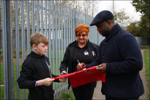 Nathan Blake signing a shirt at the Fit and Fed event in Caerphilly town