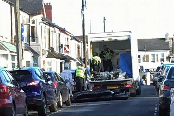 Police were seen loading evidence following the raid
