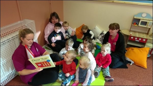 Children enjoy a story in the new toddler room