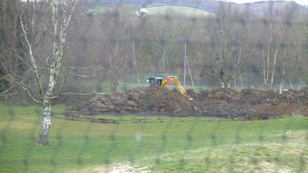 Digger moving dumped material at Virginia Park Golf Club