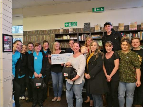 LIFESAVER: Fiona Davies, centre left with cheque, and staff from Abigail’s Nursery and the Old Library Cafe