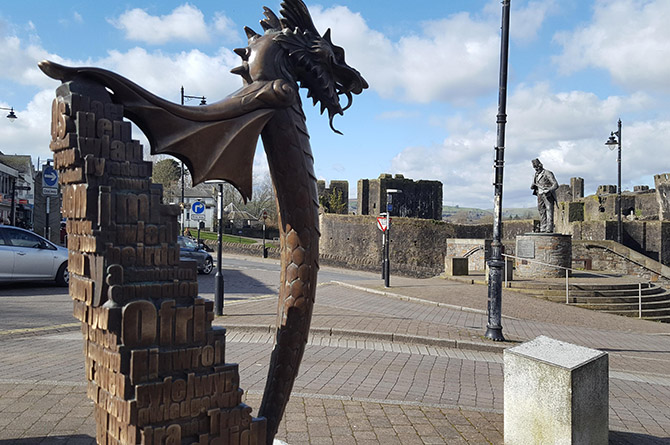The memorial with the Tommy Cooper statue in the background