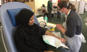 A woman donating blood at a Welsh Blood Service donation session