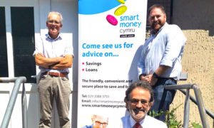 Smart Money Cymru chair Alun Taylor, front, Islwyn Credit Union director Martin Price, left, and Todd Rawson, chair of Islwyn Credit Union