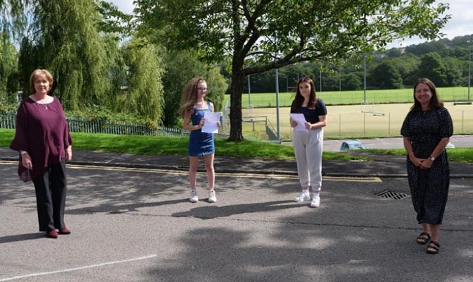 Pupils at Lewis Girls School hold their GCSE results alongside headteacher Dr Heather Duncan, left, and council leader Philippa Marsden, right
