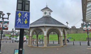 A social distancing sign near the bandstand in Caerphilly town centre