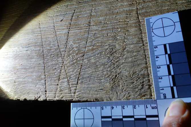 Marian marks carved into a wooden beam at Llanacaiach Fawr