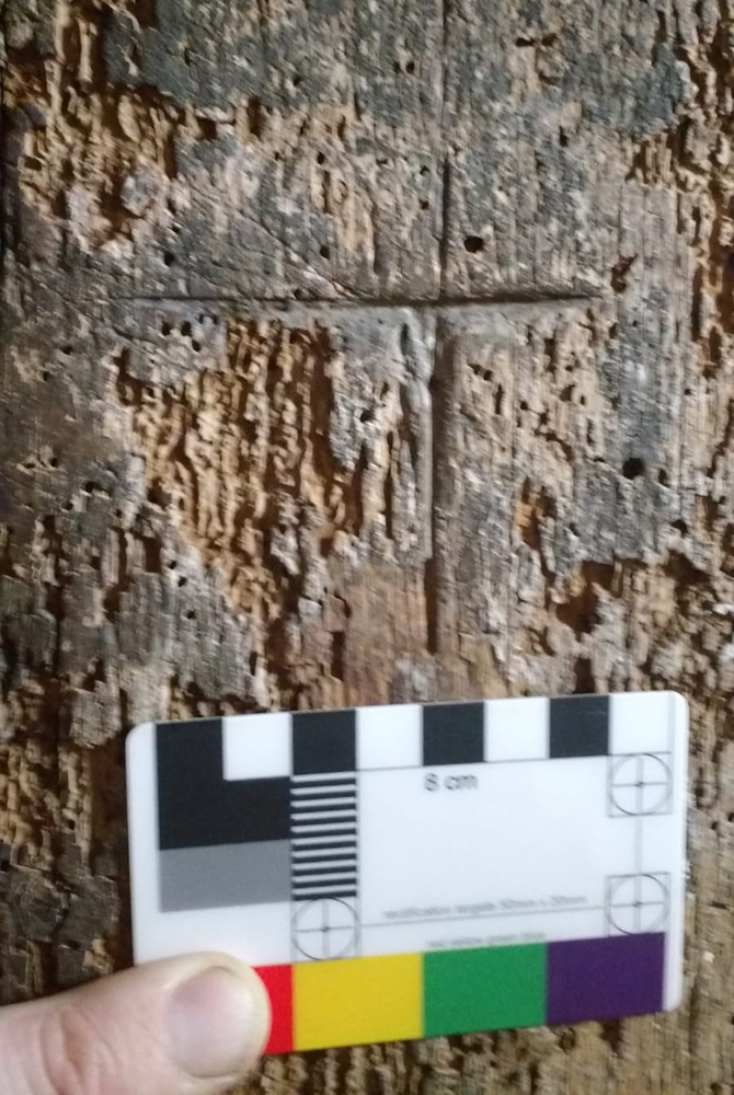 A cross symbol carved into some wood at Llancaiach Fawr