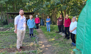 Volunteers at the Morgan Jones Park community allotments alongside Caerphilly MS Hefin David, left