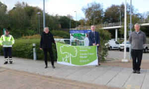 From left: council parks officer Andrew Dyer, Cllr John Ridgewell, council green spaces manager Mike Headington and parks officer Gareth Davies with the Green Flag award at the council's headquarters