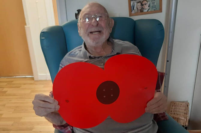 Ty Iscoed resident Harry with a giant poppy