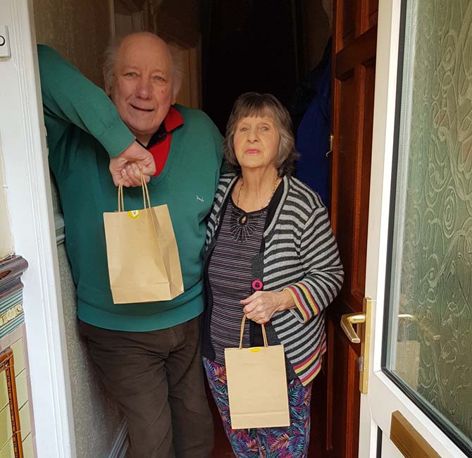 Residents receiving their Mince pies and mulled wine from Marie Curie volunteers