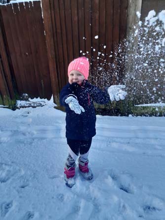 Child playing in snow Abertridwr