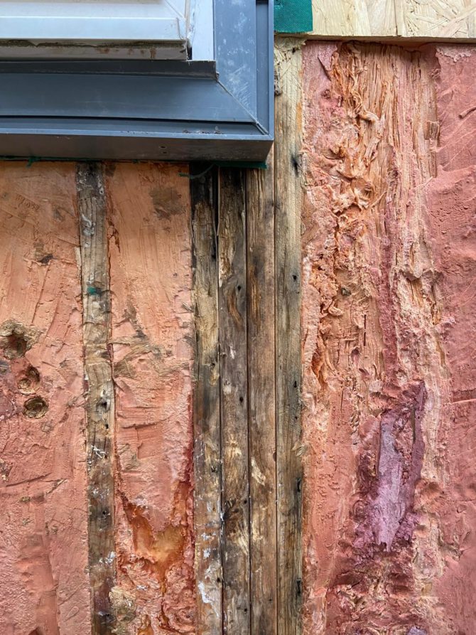 The house's wooden frame has rotted due to water damage