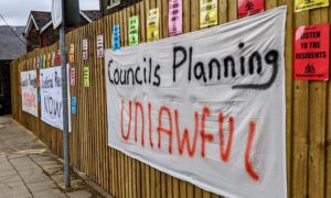 Banners calling for a judicial review outside the former Pioneer Hotel in Cwmfelinfach