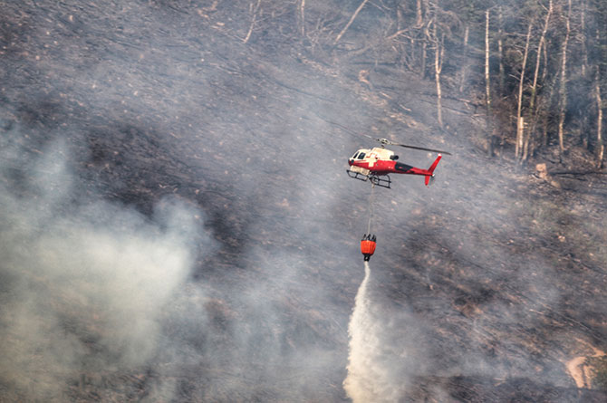 A helicopter fighting the blaze on Machen Mountain on Monday afternoon