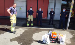 Firefighters receiving gifts from residents at Caerphilly Fire Station