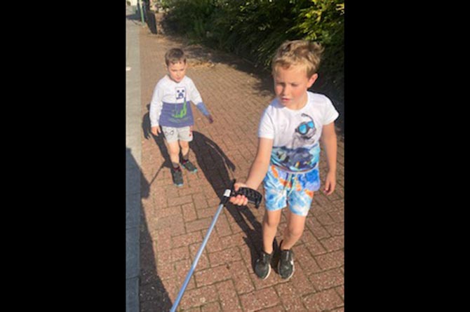 Charlie and Cameron picking up litter in Lansbury Park