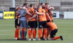 Aber Valley players huddle during their Welsh Cup tie at Aberystwyth