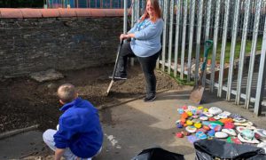 Pupils and staff at the Learning Centre in Glan y Nant working on the new wellbeing garden