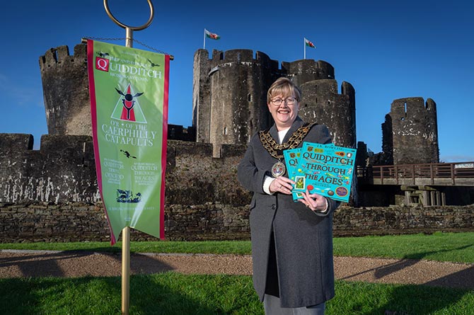 Caerphilly County Borough Mayor Cllr Carol Andrews with the Quidditch banner at Caerphilly Castle