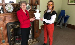 Katherine Hughes, secretary of Caerphilly Miners' Centre, is presented with a National Lottery award by singer Cerys Matthews