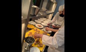 Coleg y Cymoedd students preparing food in their new kitchen