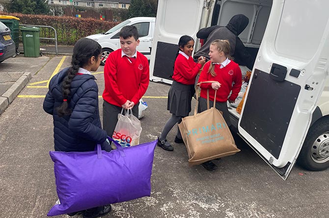 St Helens pupils loading donations for Ukraine into a van