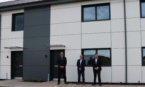 From left: Council deputy leader Jamie Pritchard, Martin Bennett of contractors Willmott Dixon, and council cabinet member for housing Shayne Cook outside the new council-owned apartments in Trecenydd