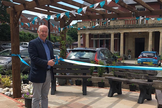 Caerphilly MP Wayne David cutting the ribbon to officially open the Caerphilly Miners' Centre's Climate Change Garden