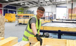 Celtic Offsite employee Joe Hammond making a timber frame