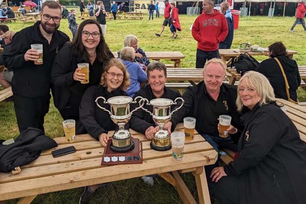 Some of the band members celebrating after winning both the fourth and third section competition
