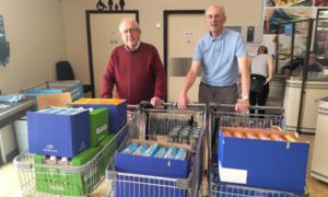 Rotary club members Reverend Trevor Morgan and David Ellis collecting food to donate to Rhymney Valley foodbank