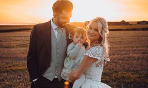 Owain James and wife Ellie on their wedding day with their daughter