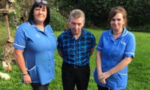 Philip Robinson with carers Sue Loxton, left, and Leanne Gardner, right
