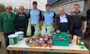 Cardiff City stars Rubin Colwill and Oliver Denham with supporters trust members David Craig, Mike Spear and Keith Morgan, as well as Stephen Holdroyd from the Rhymney Valley Foodbank